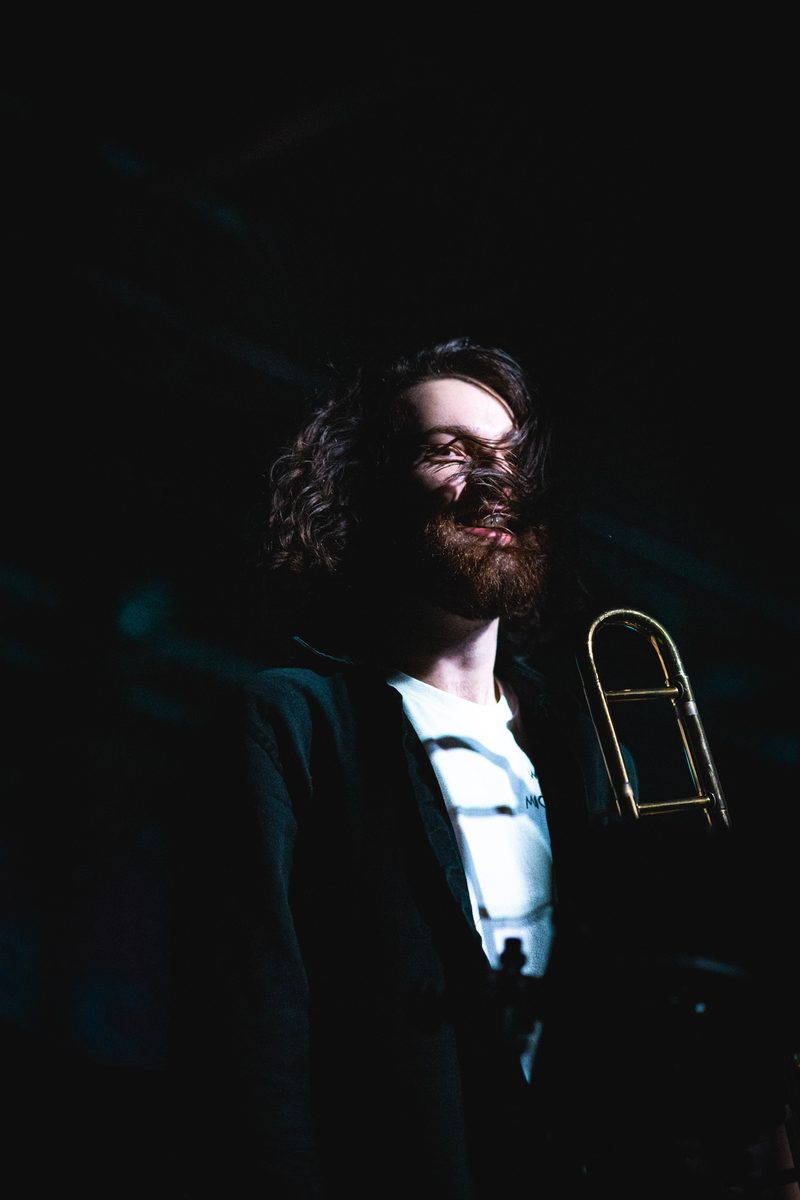 Jared Ramos with trombone, stage lighting